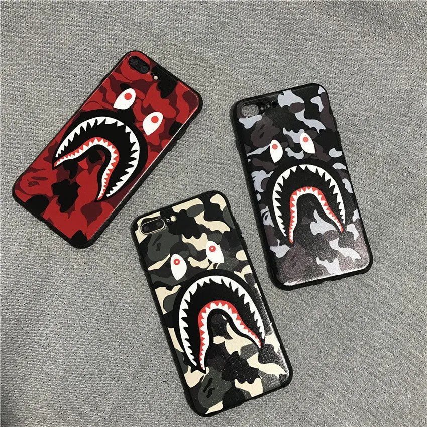 Frosted silicone phone case with shark mouth design in red, green, gray, and pink colours