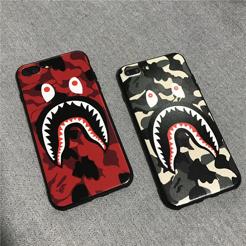 Frosted silicone phone case with shark mouth design in red, green, gray, and pink colours