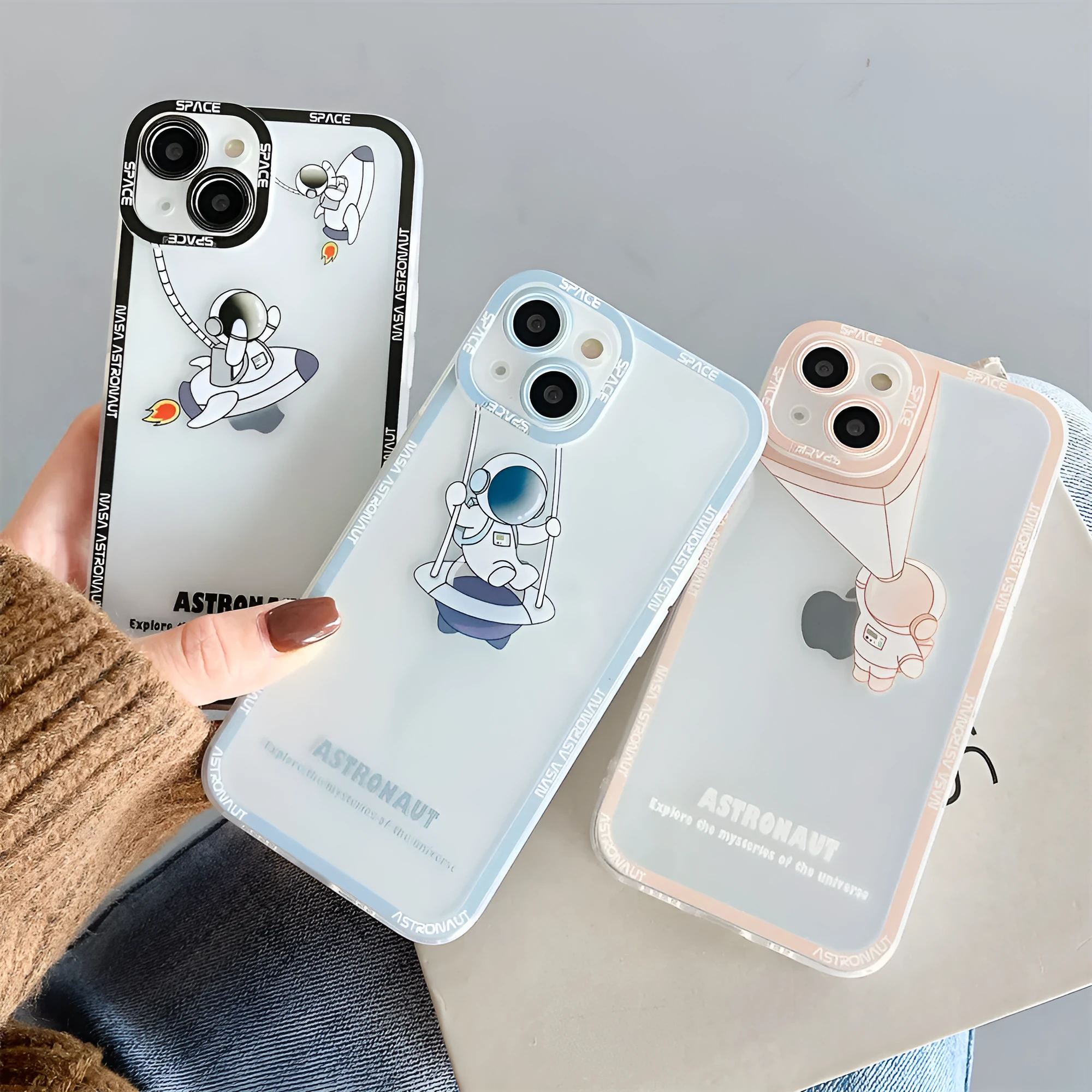 Transparent silicone iPhone case with blue astronaut print showing phone compatibility