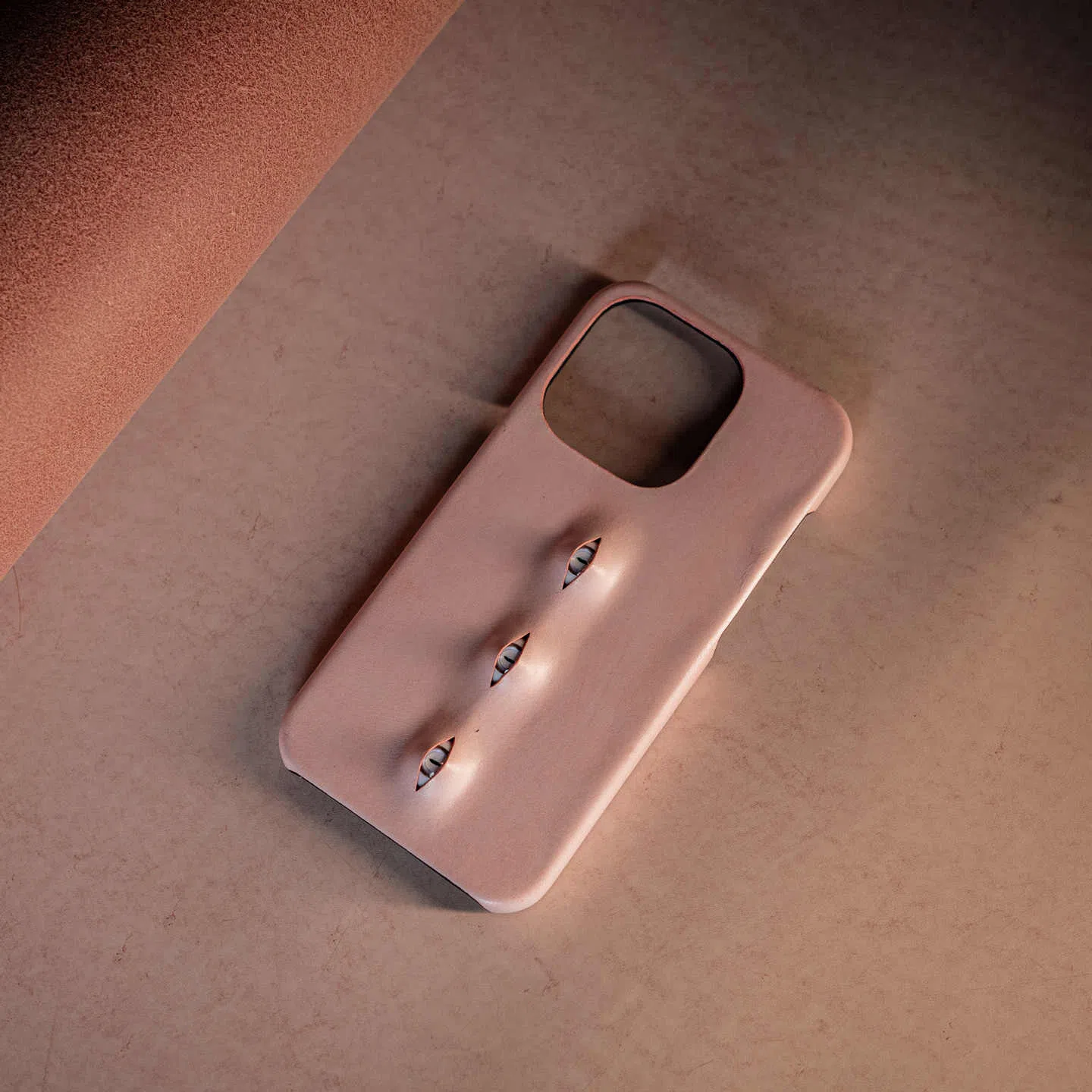 Handmade waxed cowhide leather eye phone case in pink with three-eye vertical design