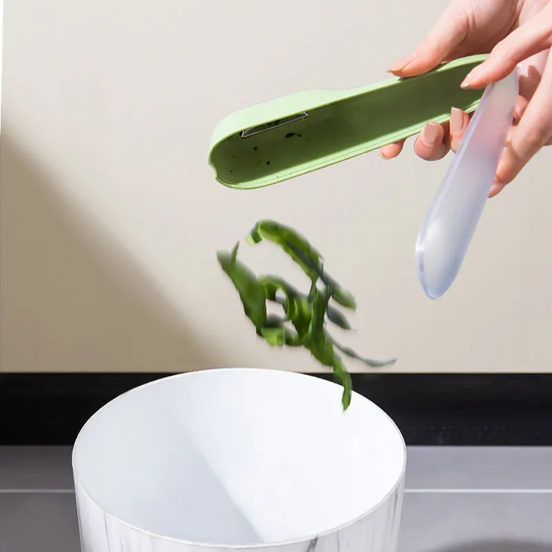 Green kitchen peeler with a stainless steel blade stored inside its transparent plastic tube.