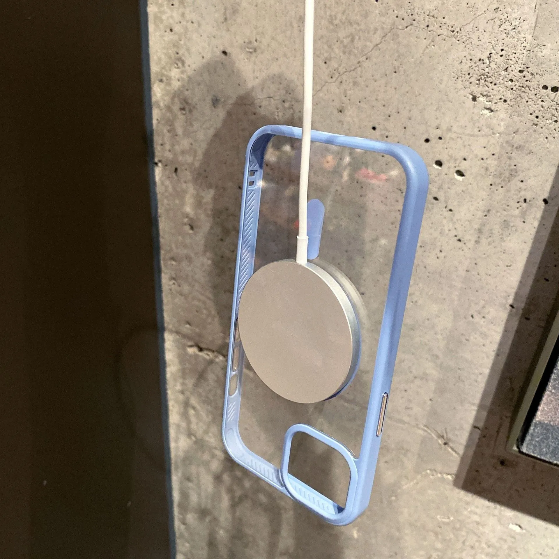 Transparent acrylic MagSafe phone case for iPhone with magnetic ring visible through clear back