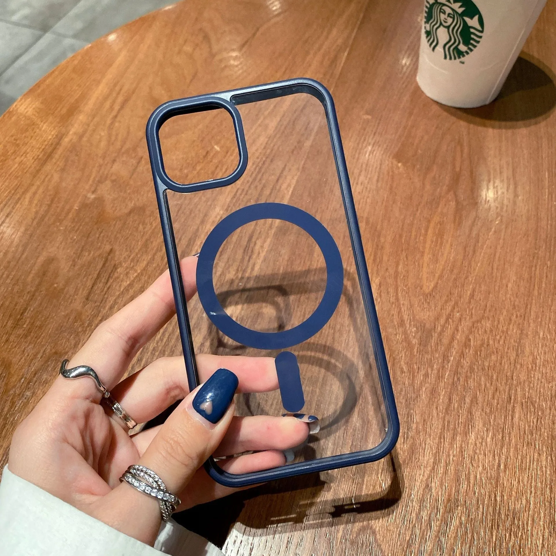 Transparent acrylic MagSafe phone case for iPhone with magnetic ring visible through clear back