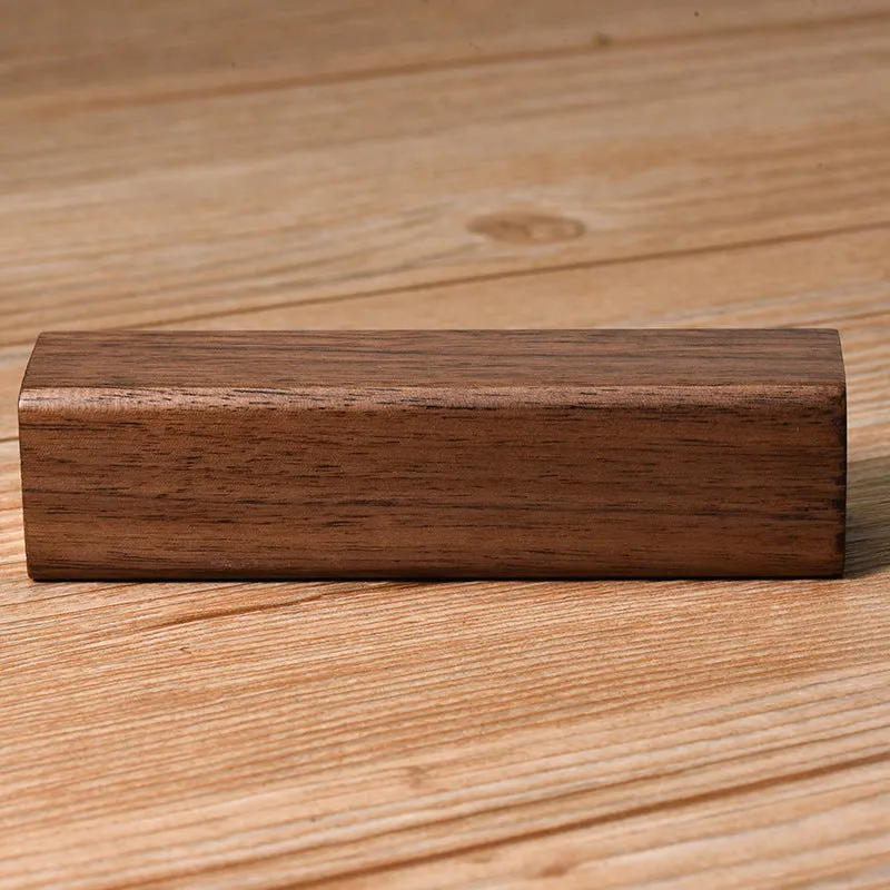 Portable power bank with brown walnut wood shell showing charging ports