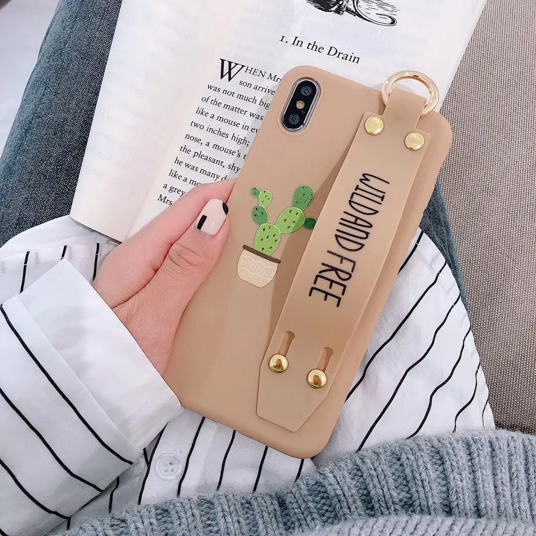 Green graffiti design wristband holder phone case for iPhone on a table.