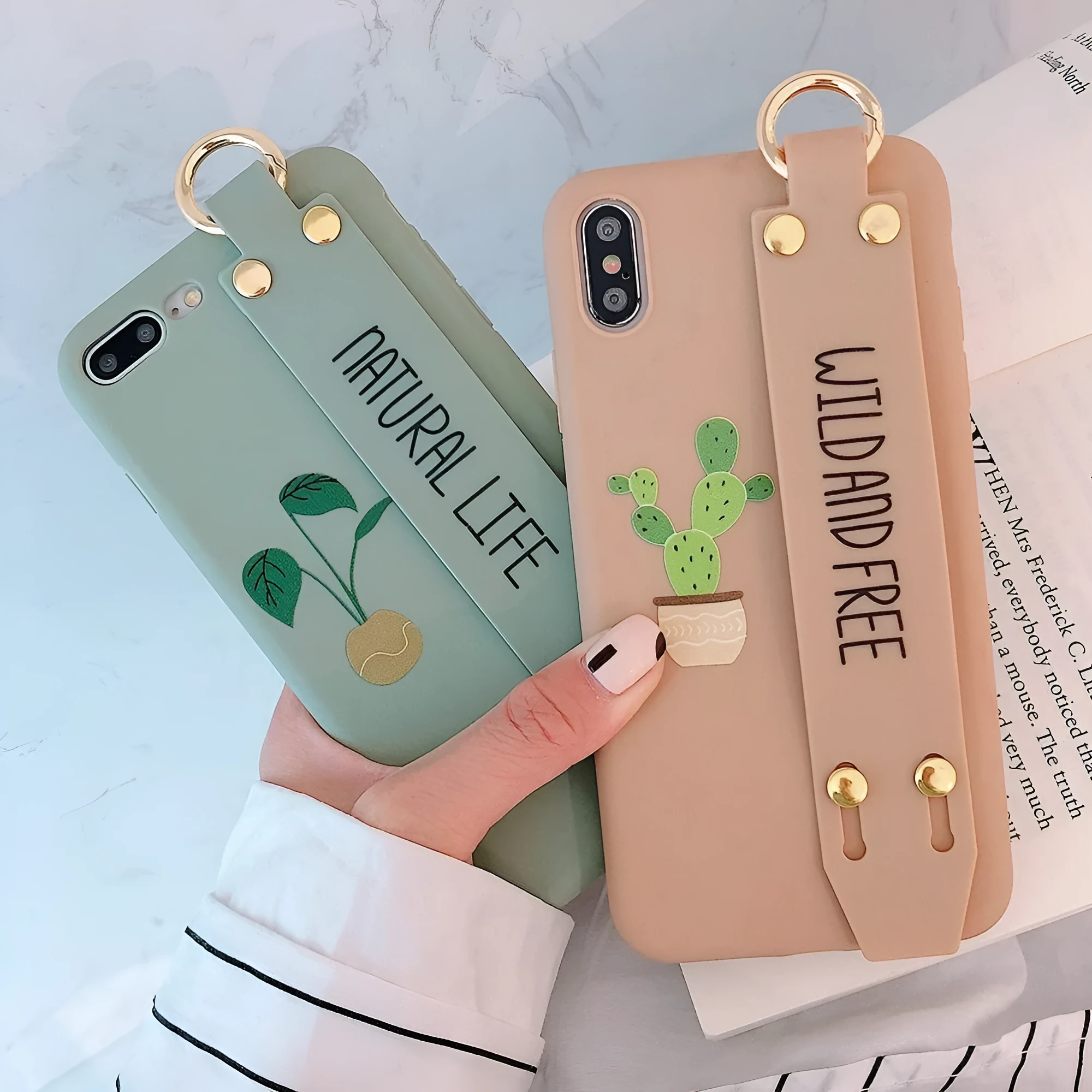 Green graffiti design wristband holder phone case for iPhone on a table.