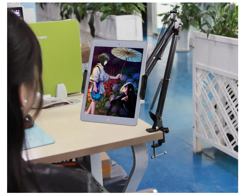 Black and white phone tablet stand on desk holding mobile device