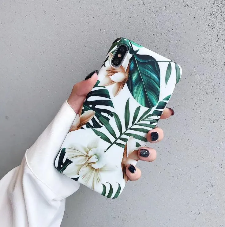 LOVECOM floral iPhone back case with banana leaf design on a smartphone.