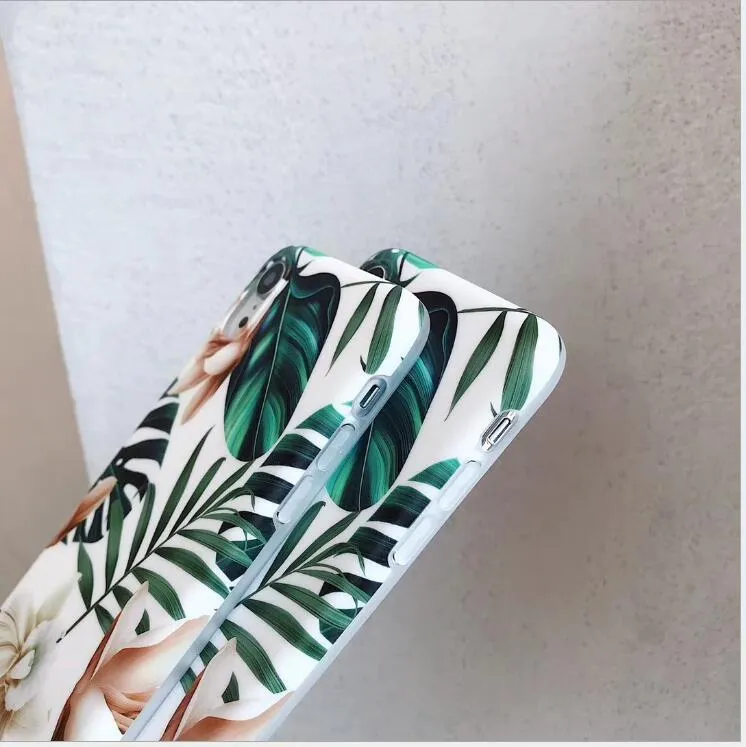 LOVECOM floral iPhone back case with banana leaf design on a smartphone.