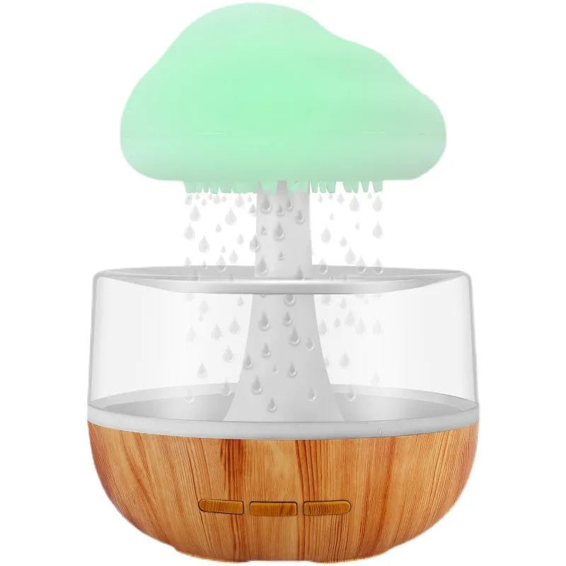 White cloud-shaped aromatherapy humidifier with colour-changing night light on a table.