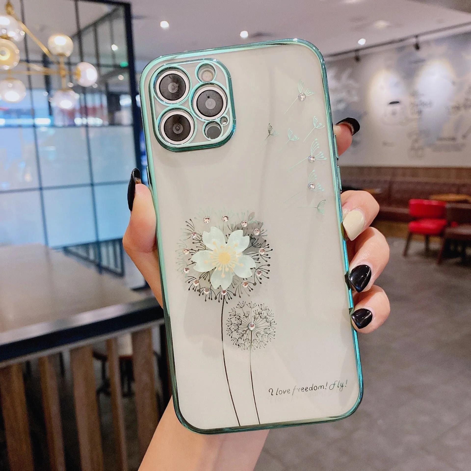 Green iPhone case with a 3D white flower spin stand on the back, showing the built-in screen protector.