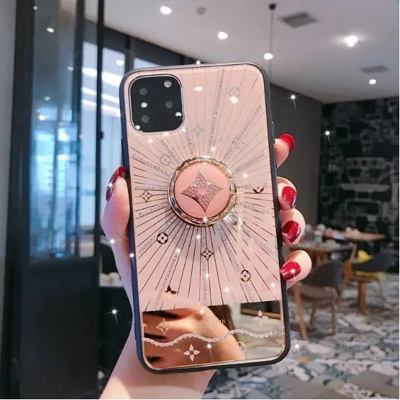 Rose gold and white diamond ring phone stands attached to iPhones, showing grip and kickstand functions.
