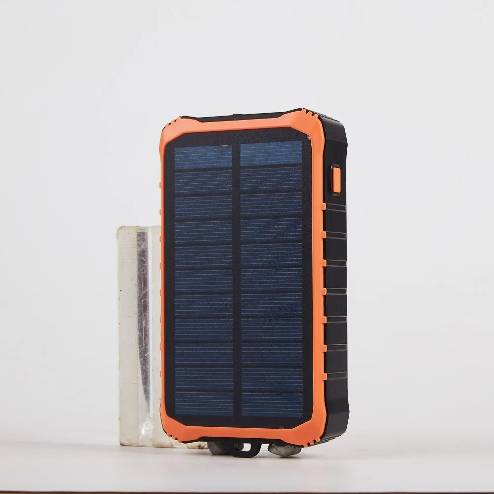 Green and orange hand solar power bank with solar panel, hand crank, and dual USB ports.