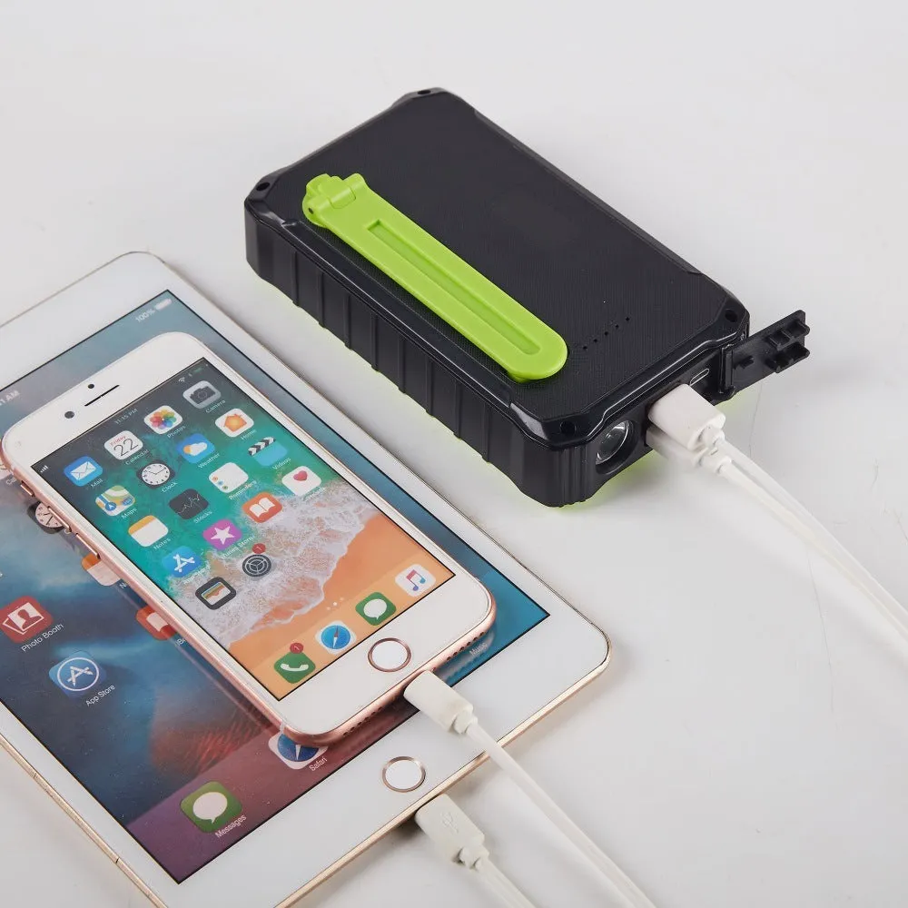 Green and orange hand solar power bank with solar panel, hand crank, and dual USB ports.
