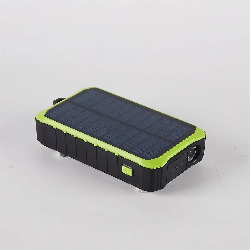 Green and orange hand solar power bank with solar panel, hand crank, and dual USB ports.