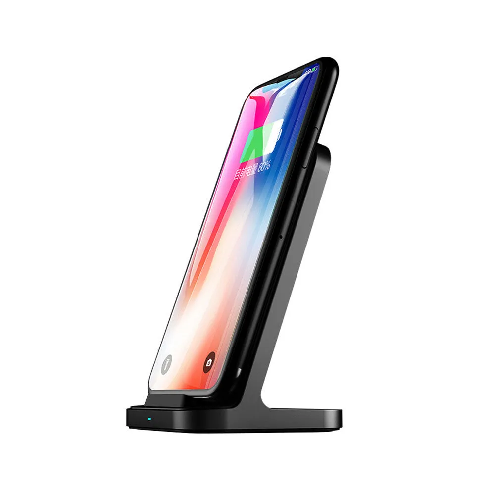 Dark grey vertical wireless charging stand for Apple iPhones on a desk