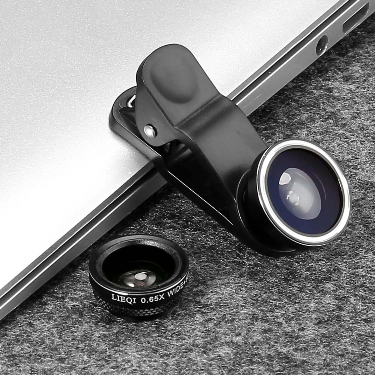 Smartphone camera lens clip kit showing four detachable lenses: wide angle, macro, fisheye and telephoto.