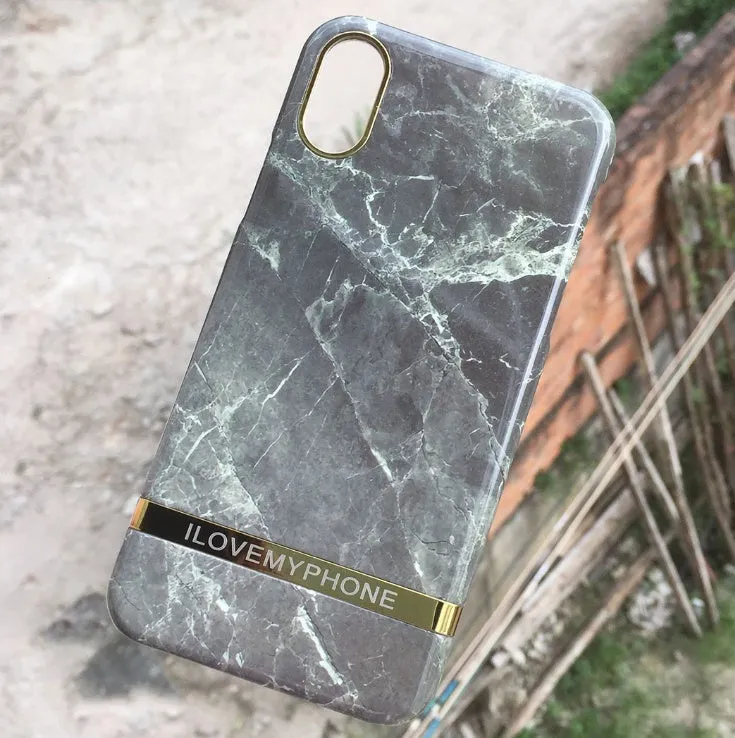 Marble pattern plastic protective case for iPhone in multiple colour options on a dark surface.