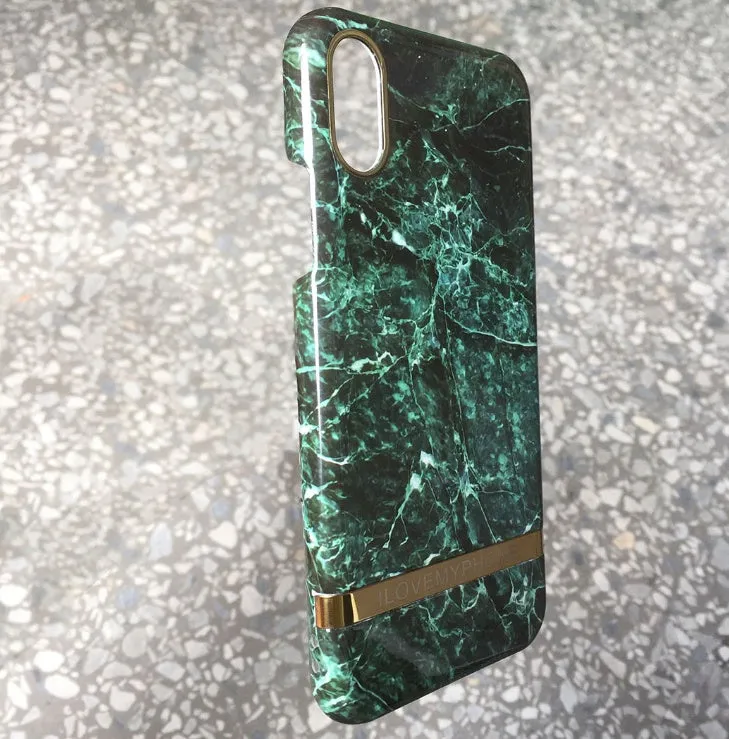Marble pattern plastic protective case for iPhone in multiple colour options on a dark surface.