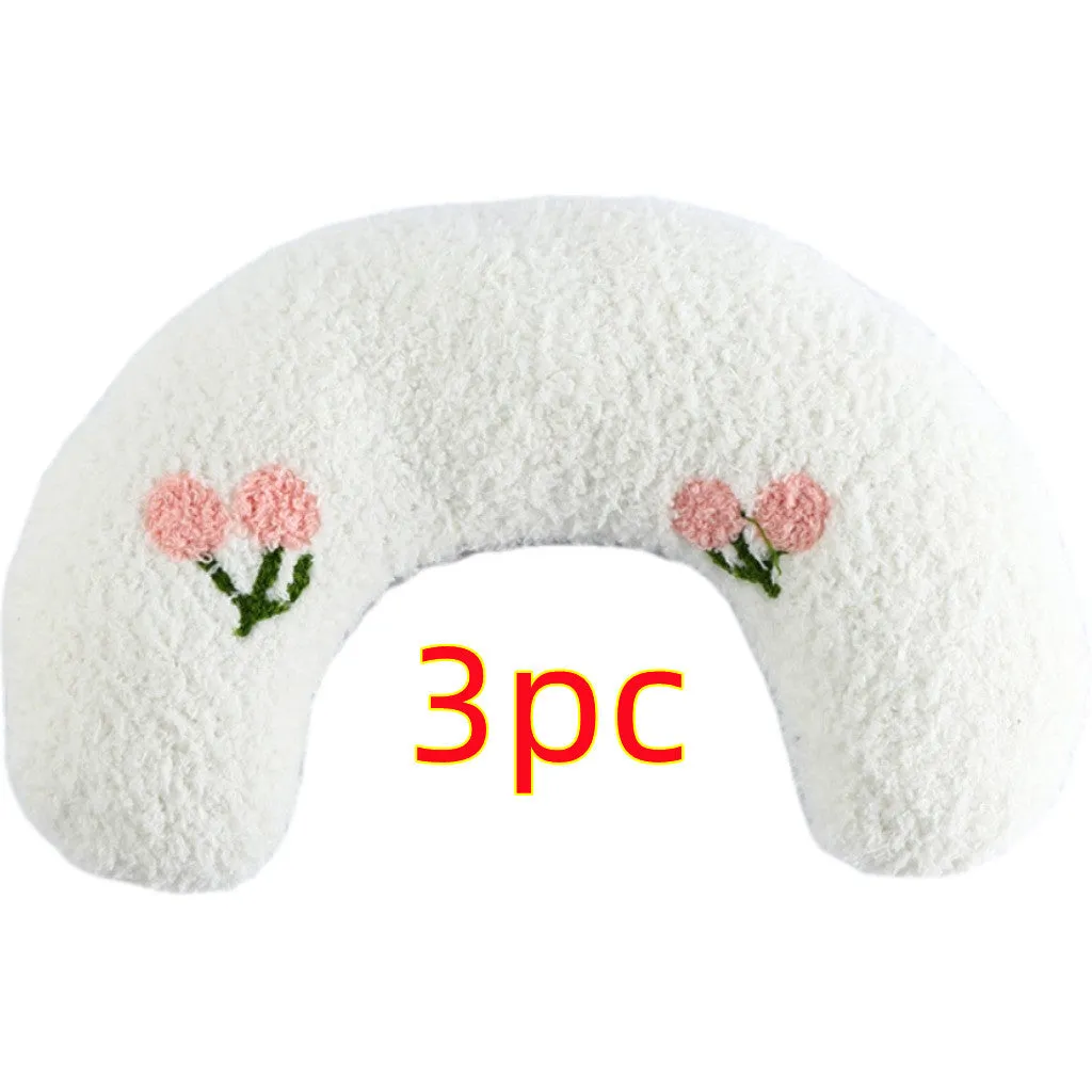 Small U-shaped plush pet pillow in blue for a cat or small dog to sleep on.