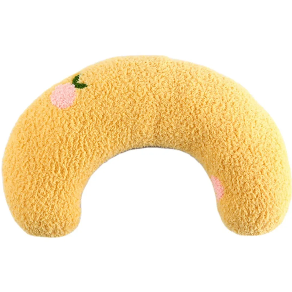 Blue U-shaped plush pet pillow for a small cat or dog on a grey background.