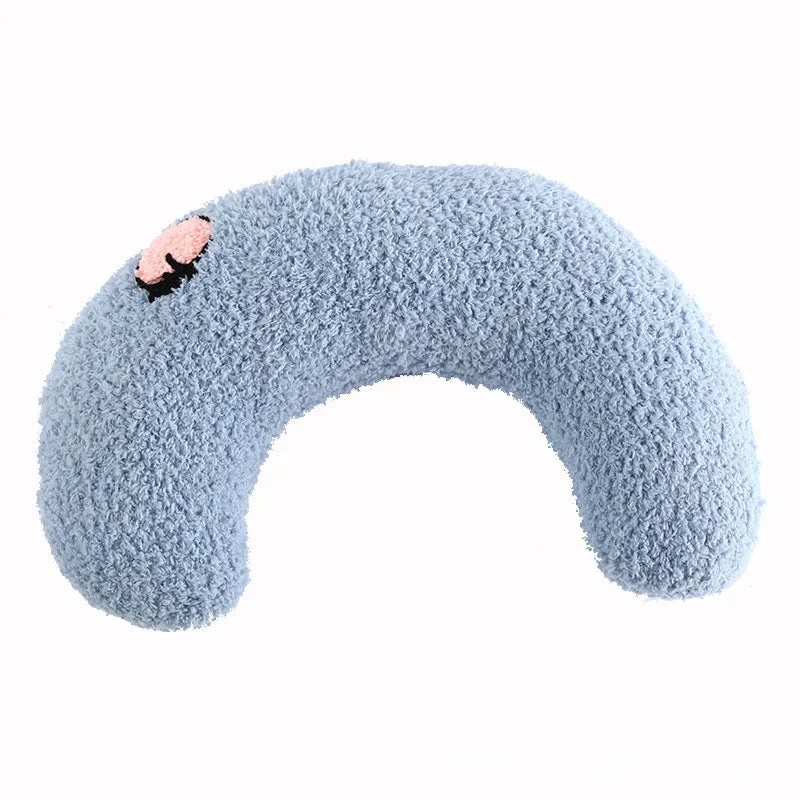 Blue U-shaped plush pet pillow for a small cat or dog on a grey background.