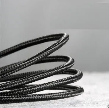 Grey and black woven nylon Android micro USB charging cable shown coiled with connector visible