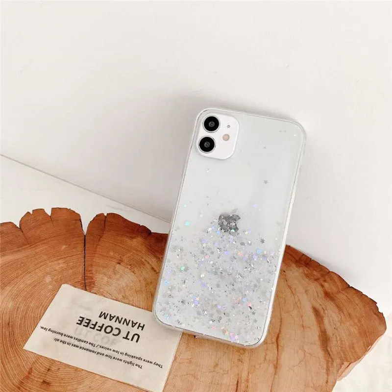 Glitter epoxy transparent phone case for iPhone 11 and iPhone 12 models on a table.