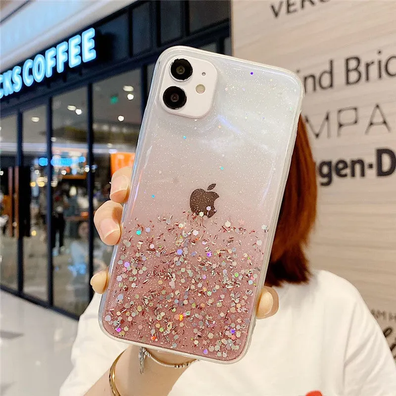 Glitter epoxy transparent phone case for iPhone 11 and iPhone 12 models on a table.