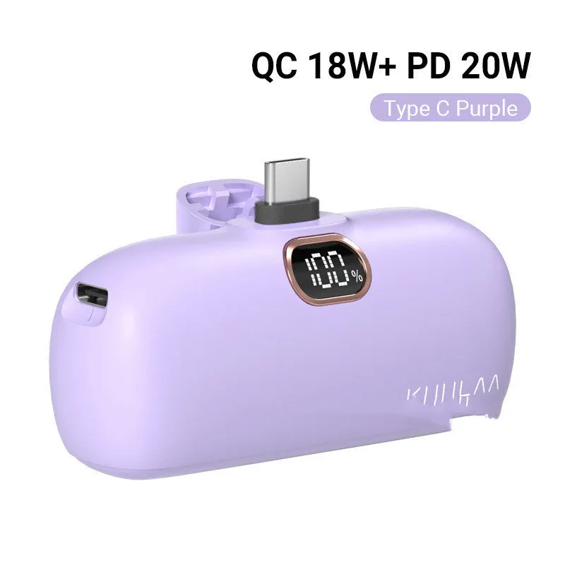 Compact cylindrical alloy power bank with built-in Lightning charging cable showing LCD display.
