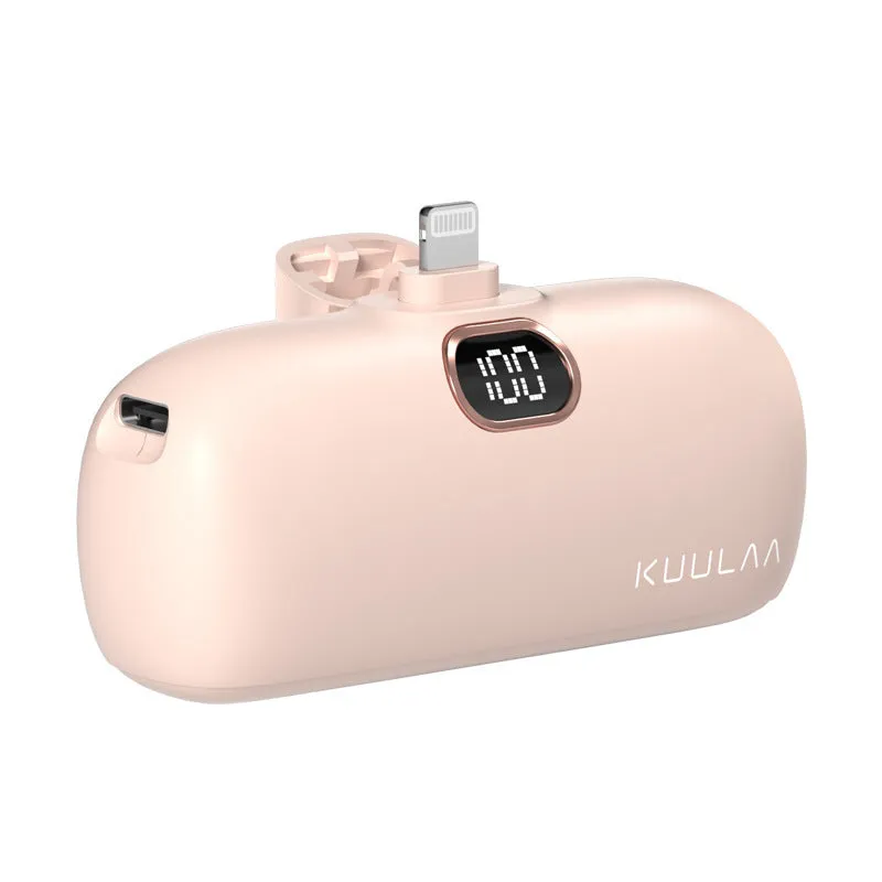 Compact cylindrical alloy power bank with built-in Lightning charging cable showing LCD display.