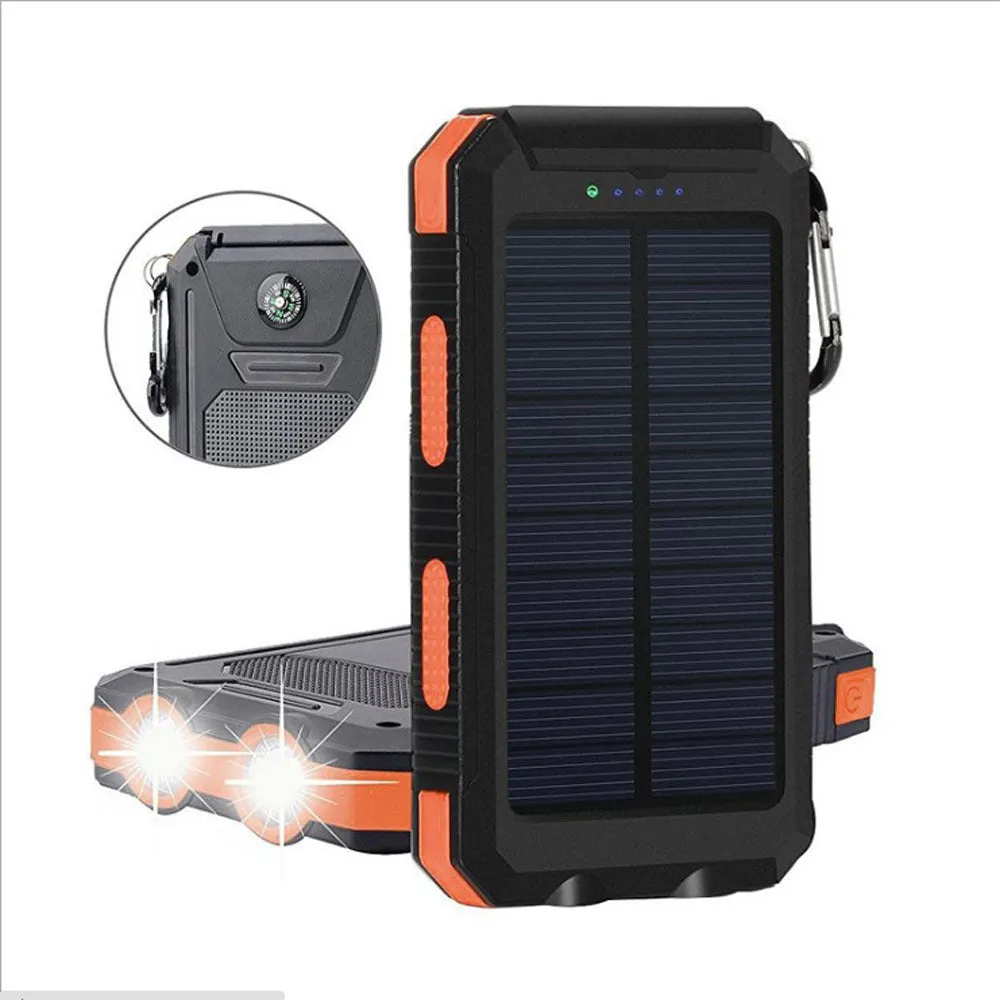 Black solar power bank showing LED flashlight, digital compass display, and solar panel on a rugged outdoor surface.