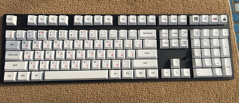 PBT sublimation keycap set showing Japanese, Russian, and Korean characters on mechanical keyboard keys
