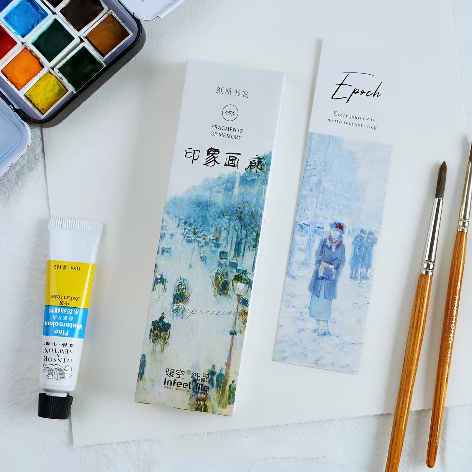 Pack of 30 white cardboard art bookmarks with designs including flowers and patterns, next to their plastic carton.