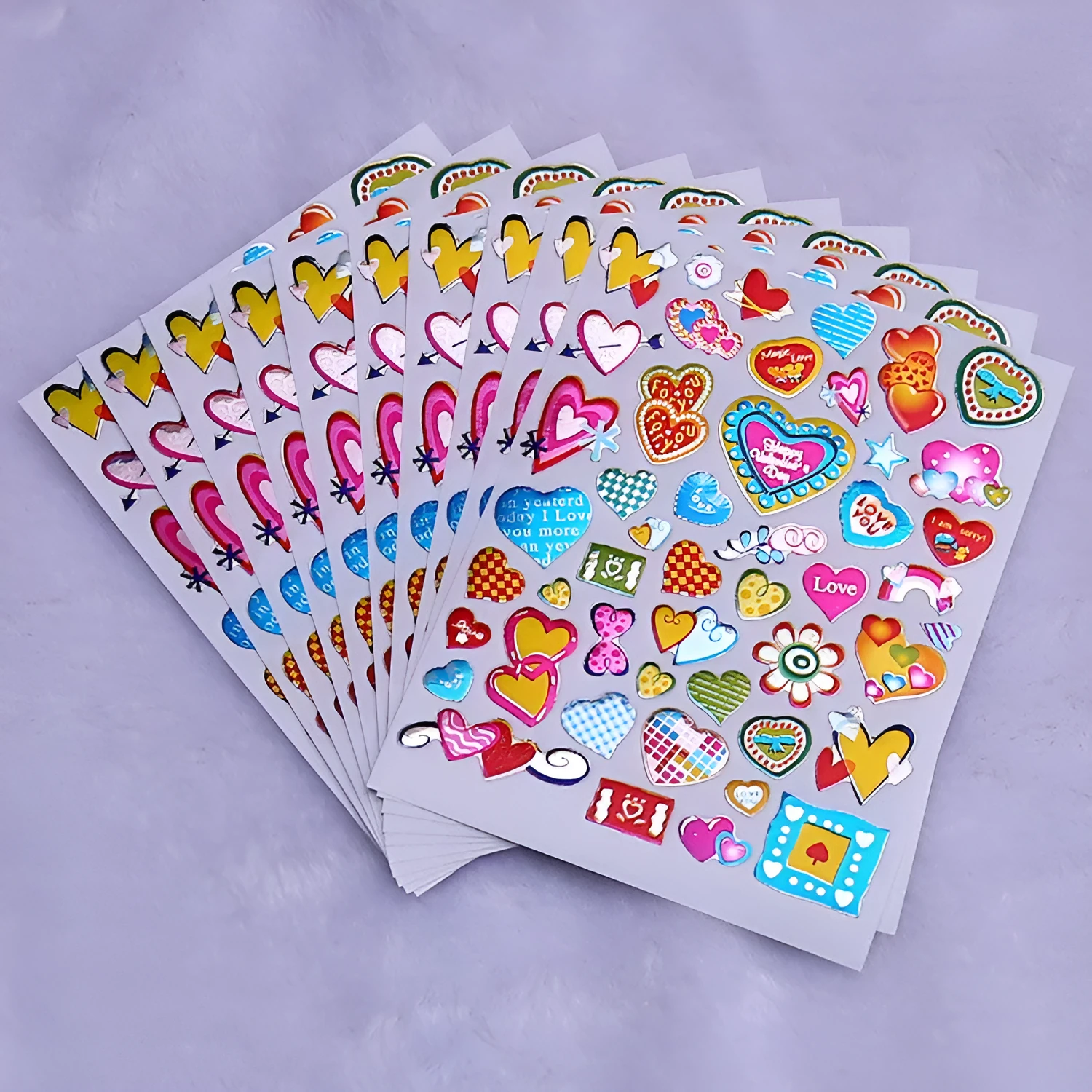 Waterproof plastic reward stickers with gilded cartoon heart designs in 100-piece pack