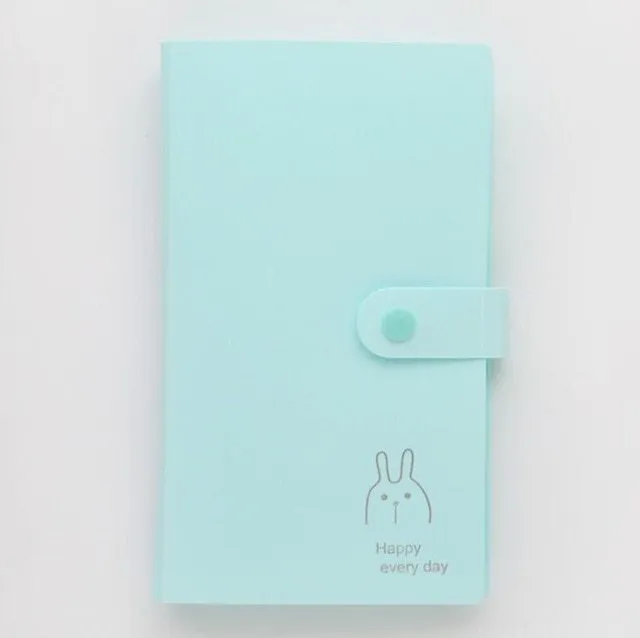Blue PVC business card holder book with a protective shell and smile logo, shown next to business cards.