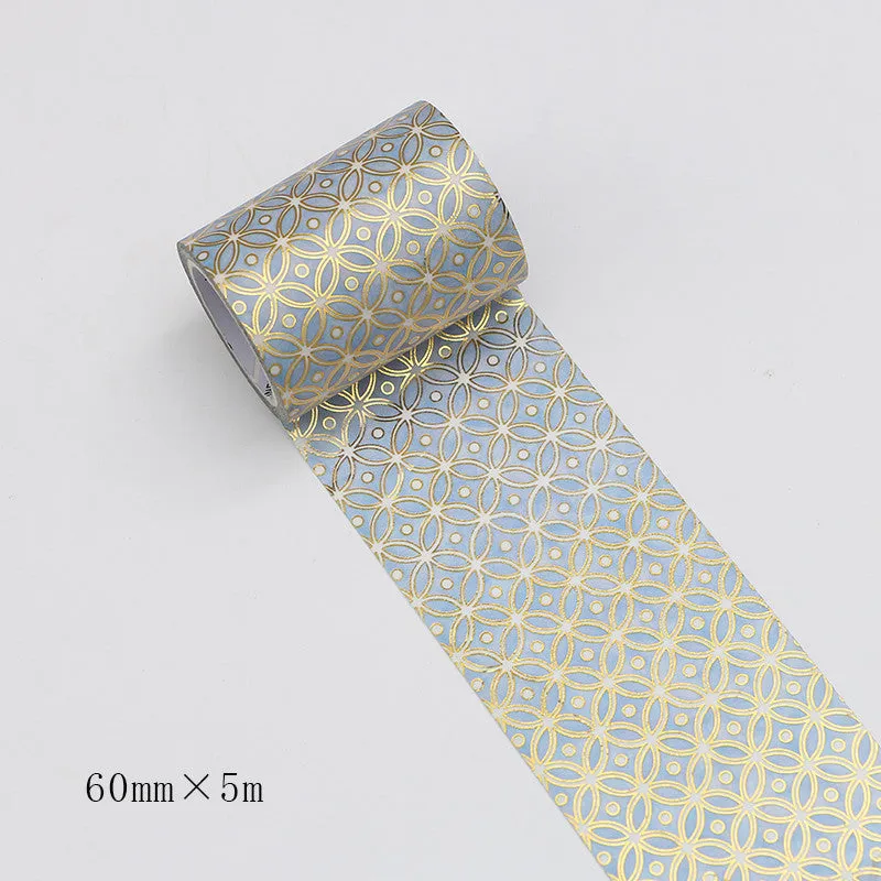 Roll of bronzing and paper decorative tape in gold colour, showing metallic finish.