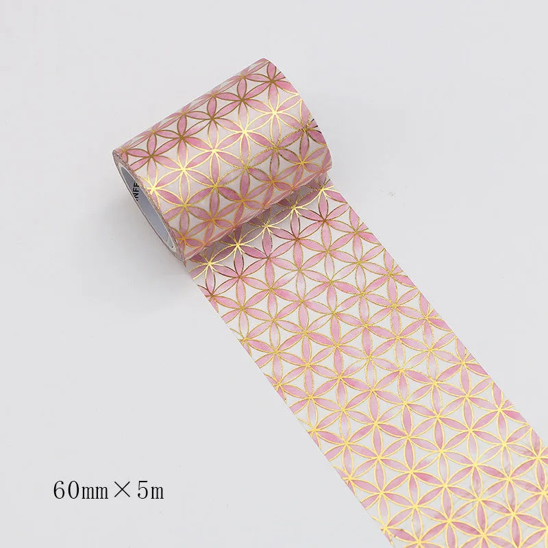 Roll of bronzing and paper decorative tape in gold colour, showing metallic finish.