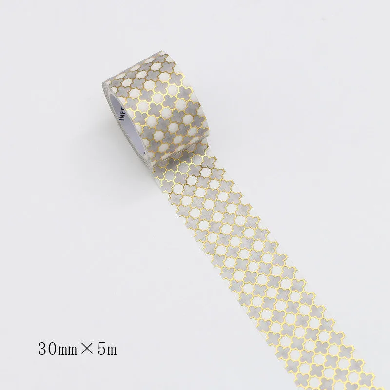 Roll of bronzing and paper decorative tape in gold colour, showing metallic finish.