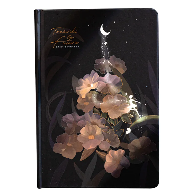 A5 notebook with luminous cover and silver foiling, open to show pages with colour illustrations.