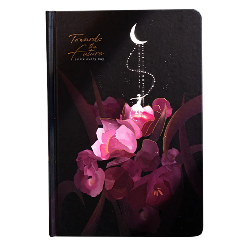 A5 notebook with luminous cover and silver foiling, open to show pages with colour illustrations.