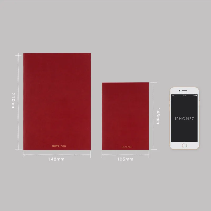Red imitation leather hand book grid notebook showing inner core dot matrix pages with bronze detailing