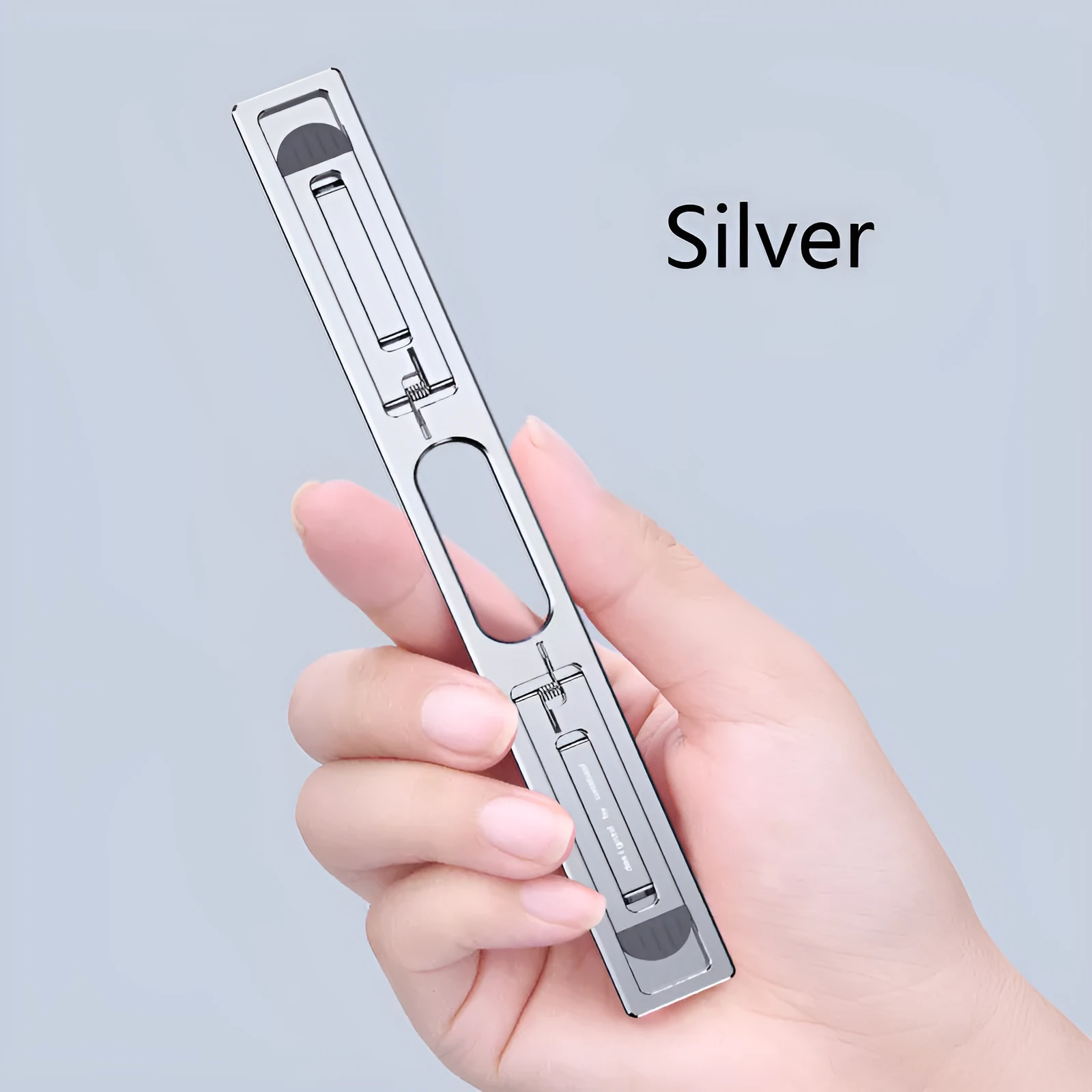 Aluminium adjustable laptop cooling bracket in silver or grey on desktop