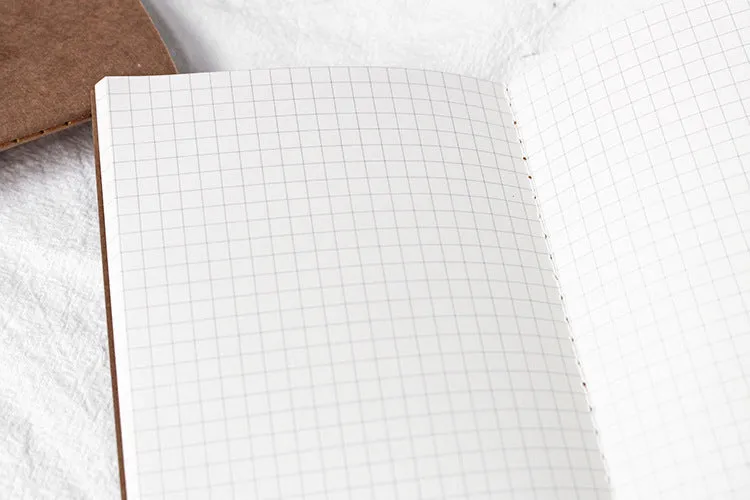 11x21cm cowhide diary refill notebook with saddle stitch binding and ivory white paper pages.