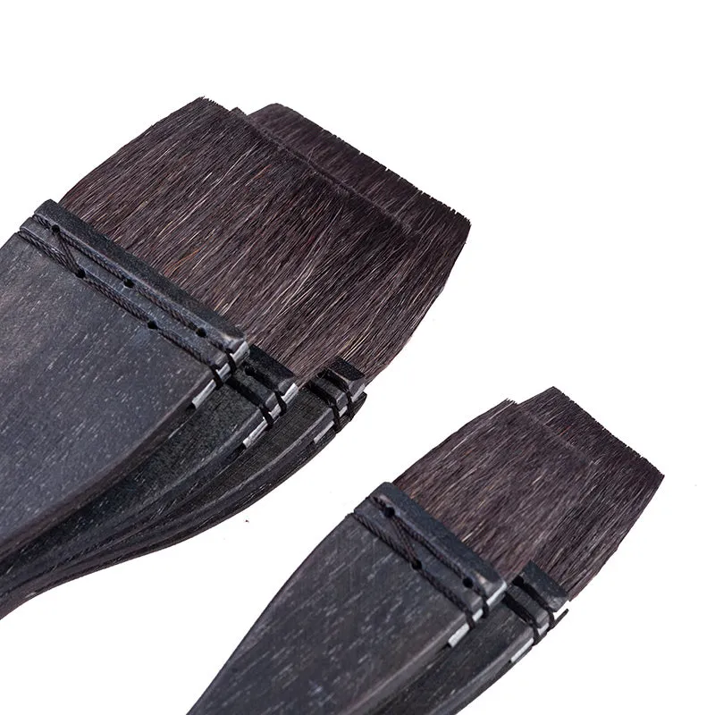 Squirrel hair makeup brush with natural wood handle on a clean surface.