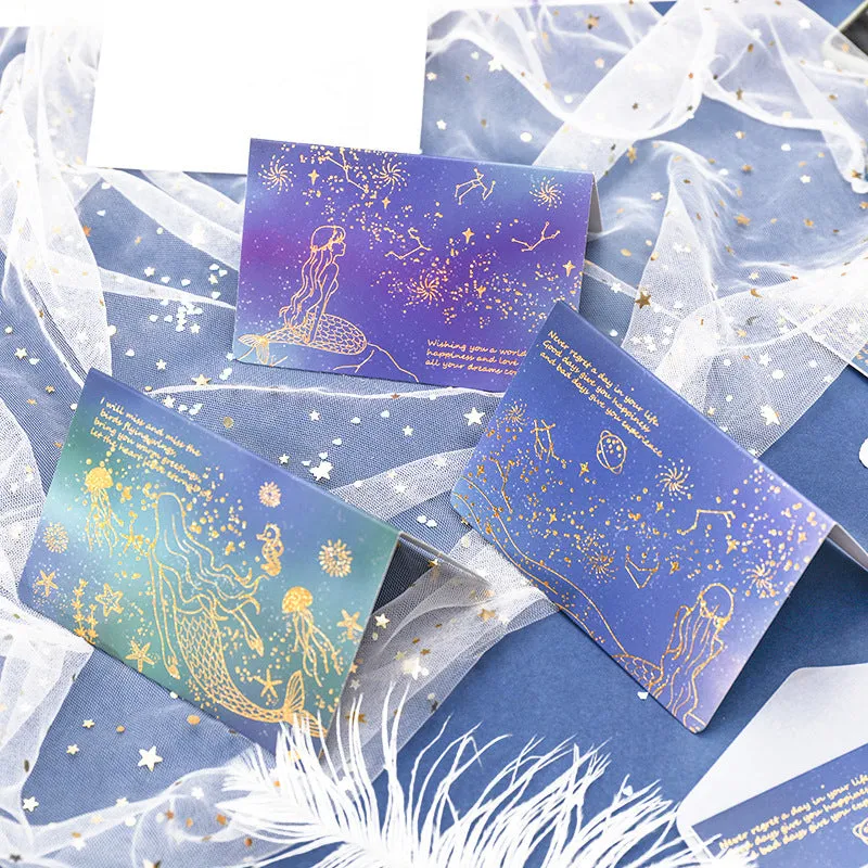 Set of three foldable sulfuric acid paper greeting card envelopes with bronzing, in celestial colours.