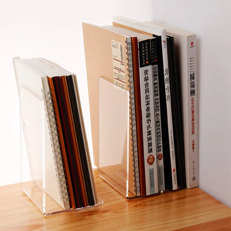 Clear transparent acrylic bookshelf holding a small stack of books on a desk.