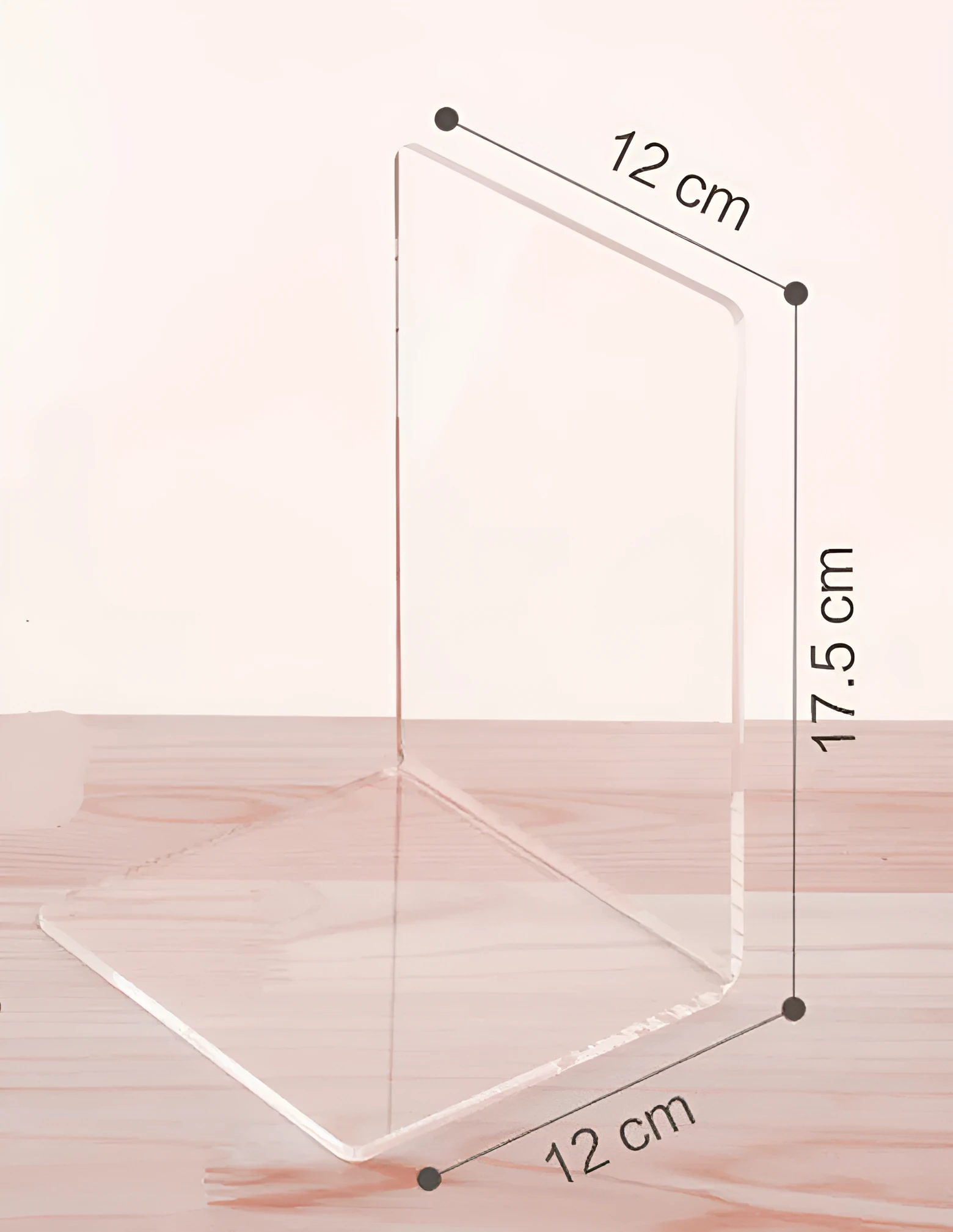 Clear transparent acrylic bookshelf holding a small stack of books on a desk.