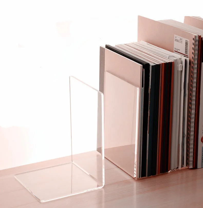 Clear transparent acrylic bookshelf holding a small stack of books on a desk.