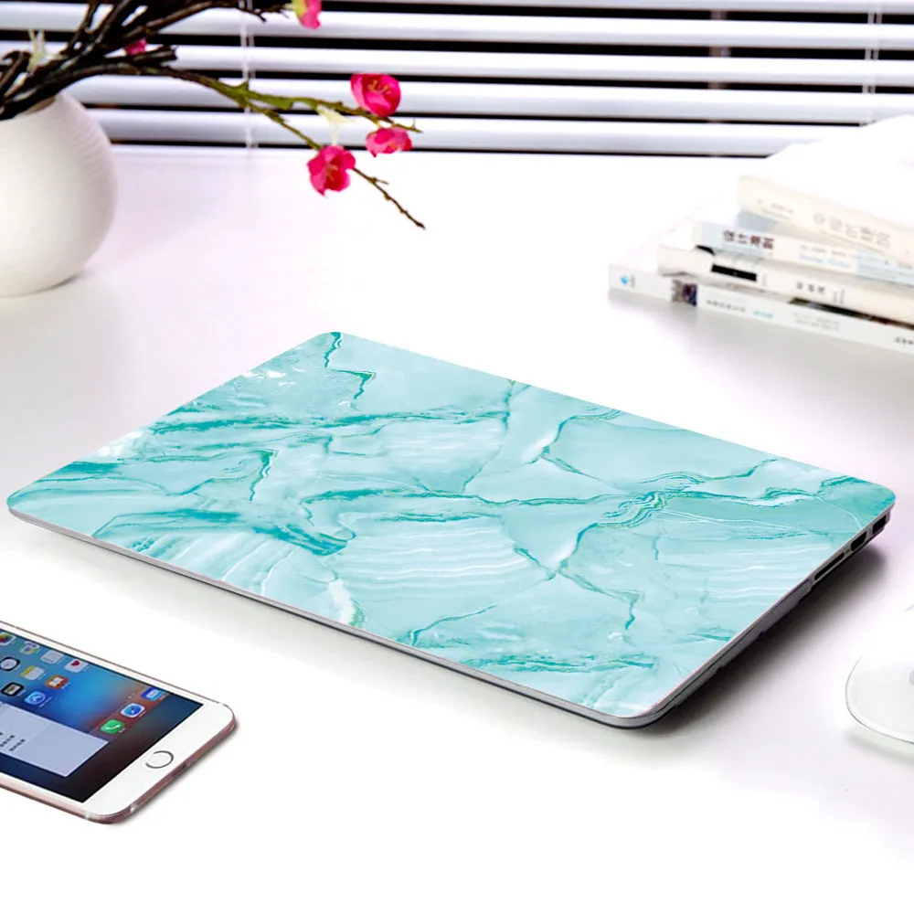 Plastic marble finish protective case for a MacBook laptop in light blue colour.